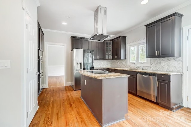 kitchen featuring a center island, island range hood, sink, appliances with stainless steel finishes, and light hardwood / wood-style floors