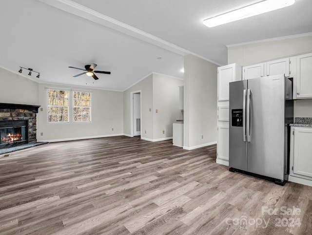 kitchen with ceiling fan, stainless steel fridge with ice dispenser, light hardwood / wood-style flooring, white cabinets, and ornamental molding