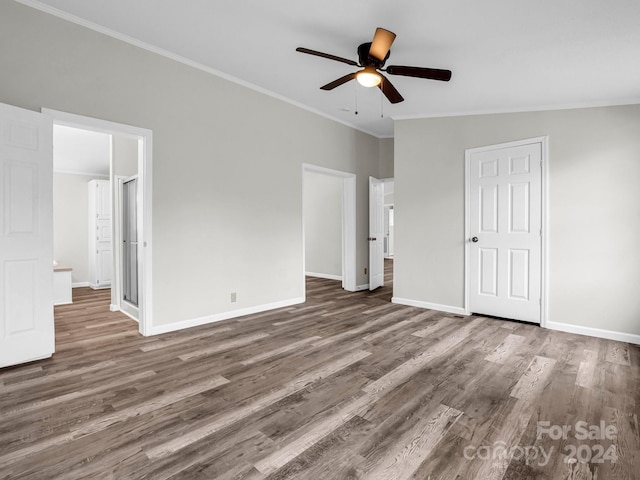 unfurnished bedroom featuring ceiling fan, dark hardwood / wood-style flooring, lofted ceiling, and ornamental molding