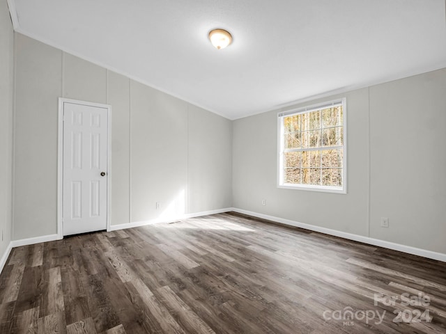 spare room featuring dark hardwood / wood-style flooring