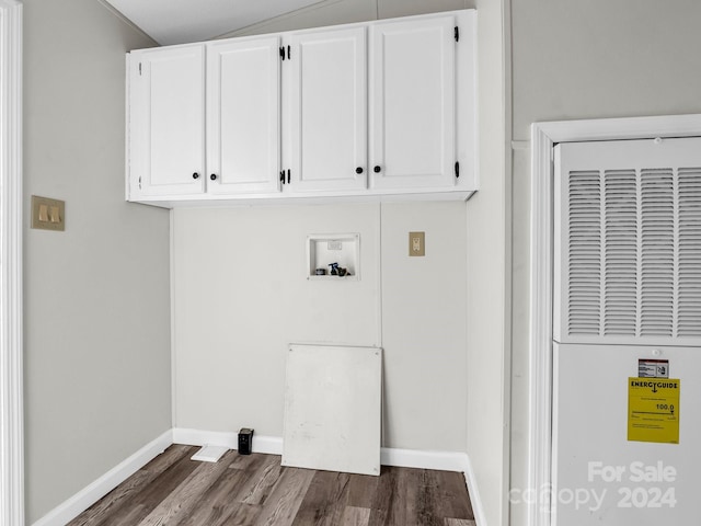 clothes washing area featuring dark hardwood / wood-style flooring, cabinets, and washer hookup