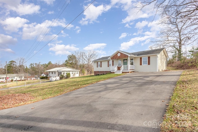 ranch-style home with a porch and a front yard