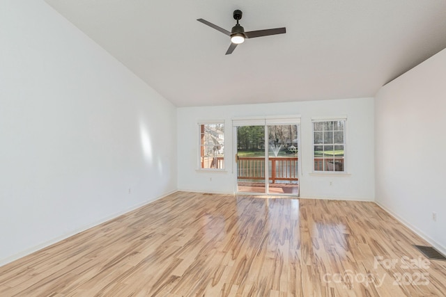 empty room with ceiling fan and light hardwood / wood-style floors