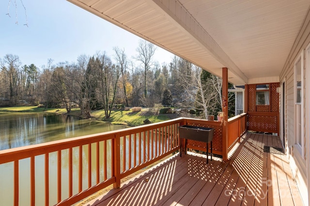 wooden terrace featuring a water view