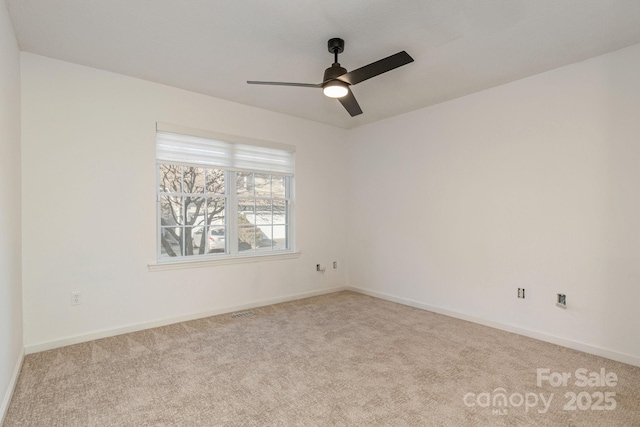 carpeted spare room featuring ceiling fan