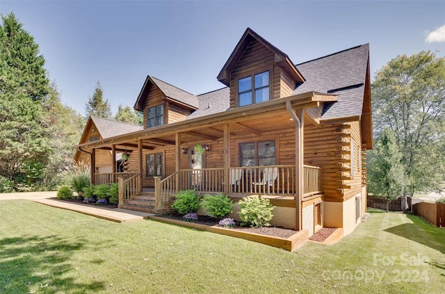 cabin with a porch and a front lawn