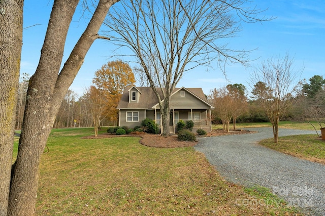 view of front of home with a porch and a front lawn