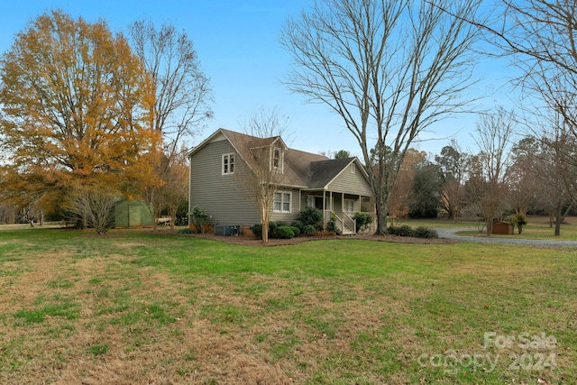 view of front of house with covered porch and a front lawn