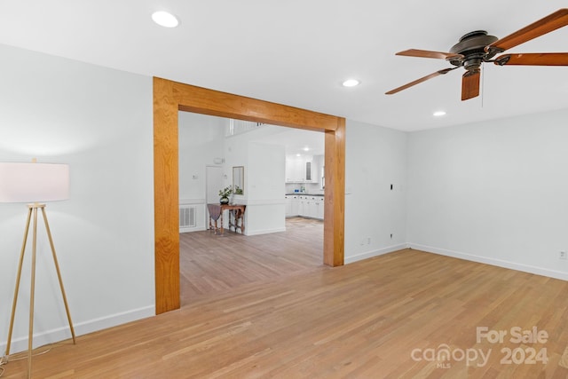 spare room with light wood-type flooring and ceiling fan