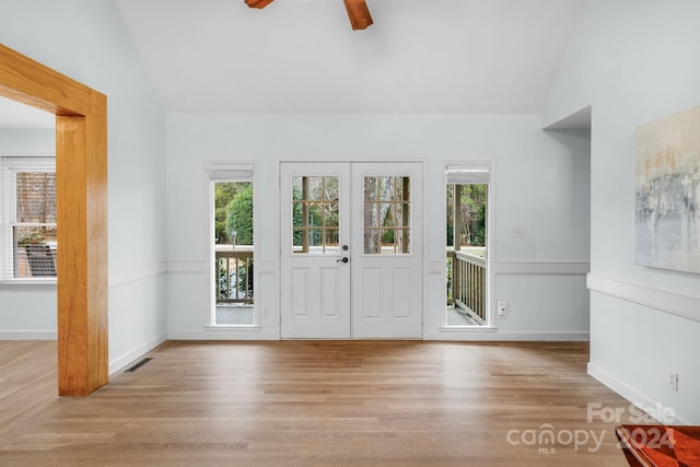 entrance foyer with ceiling fan, light hardwood / wood-style floors, and lofted ceiling