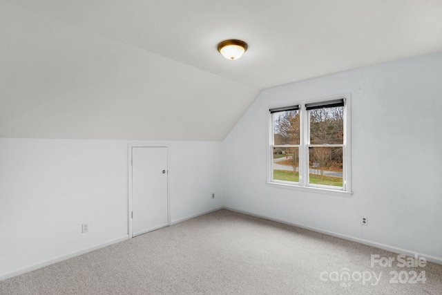 bonus room featuring carpet flooring and vaulted ceiling