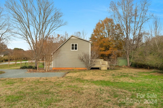 view of side of home with a lawn