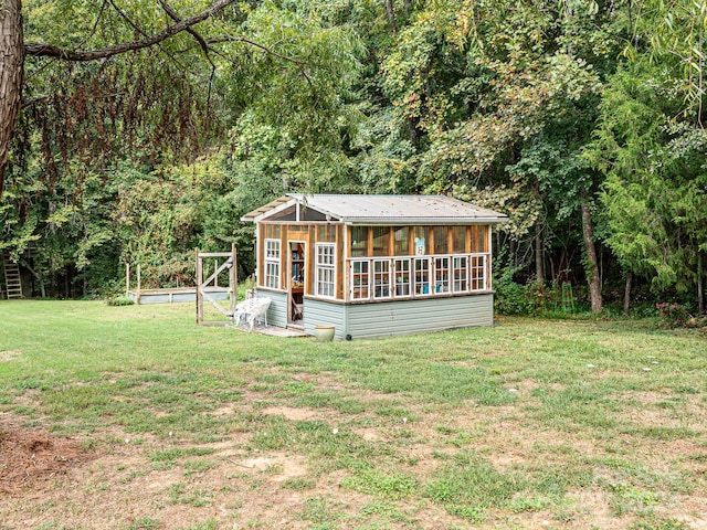 exterior space with a lawn and an outdoor structure