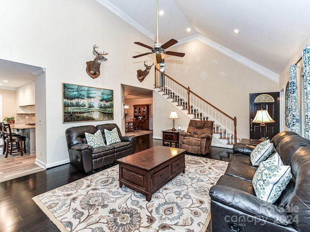 living room with hardwood / wood-style flooring, ceiling fan, and ornamental molding