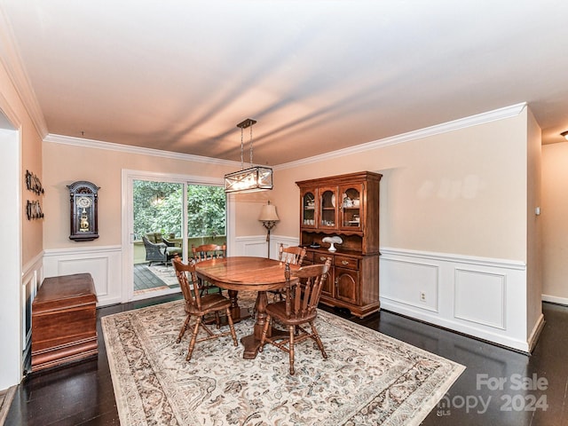 dining space with dark wood-type flooring and ornamental molding