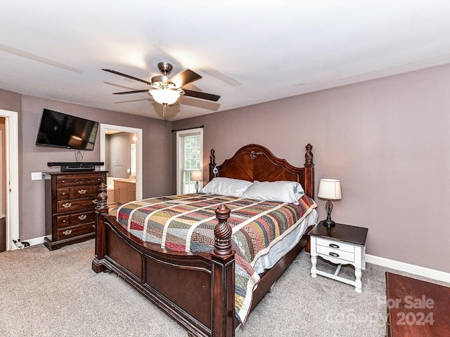 carpeted bedroom with ensuite bathroom and ceiling fan