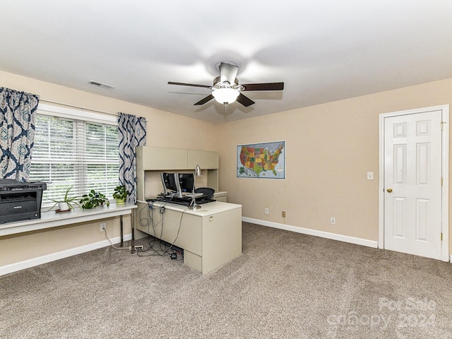 carpeted office featuring ceiling fan