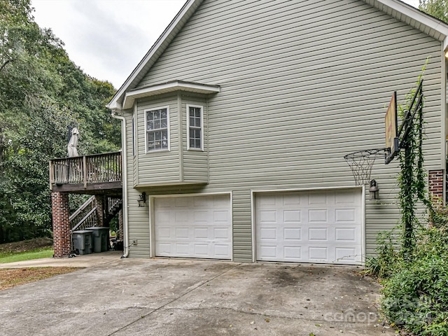 view of side of home with a wooden deck and a garage