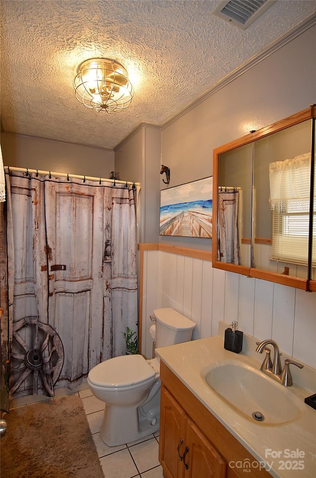 bathroom featuring vanity, tile patterned flooring, a shower with shower curtain, toilet, and a textured ceiling