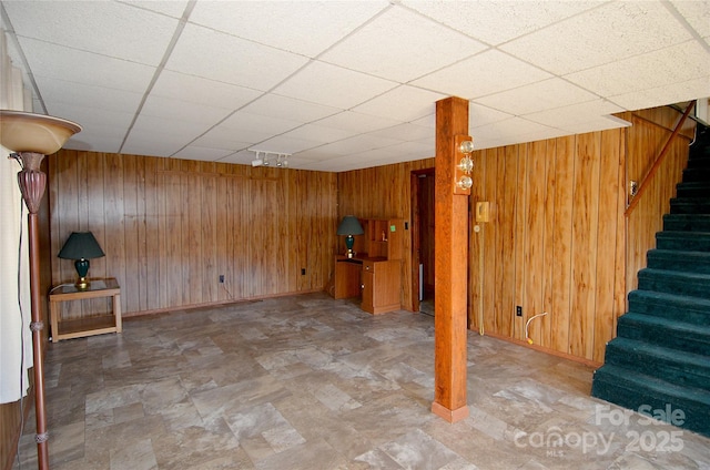 basement featuring wooden walls