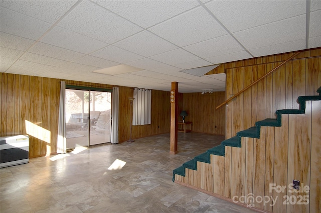 basement featuring wooden walls