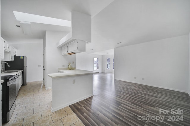 kitchen with white cabinets, dishwasher, kitchen peninsula, and sink