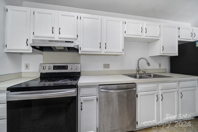 kitchen with appliances with stainless steel finishes, white cabinetry, and sink