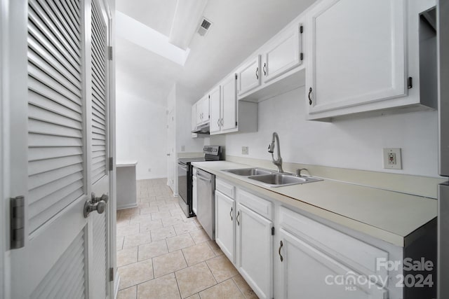 kitchen featuring light tile patterned flooring, white cabinetry, sink, and stainless steel appliances