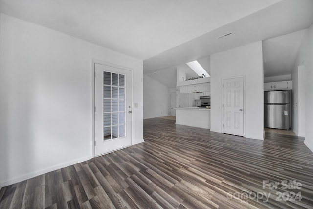 unfurnished living room with lofted ceiling and dark wood-type flooring