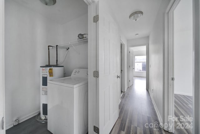 laundry room featuring washer / clothes dryer, water heater, and dark wood-type flooring