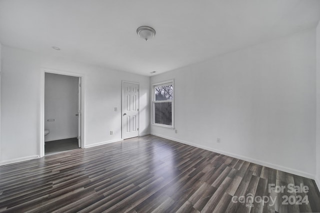 empty room with dark wood-type flooring