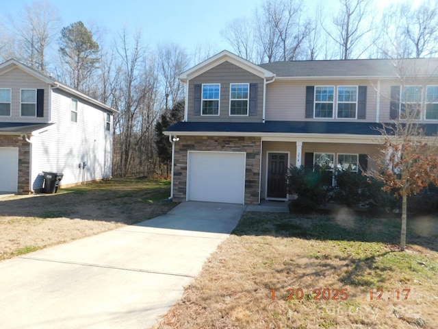 view of front of property featuring a front lawn and a garage