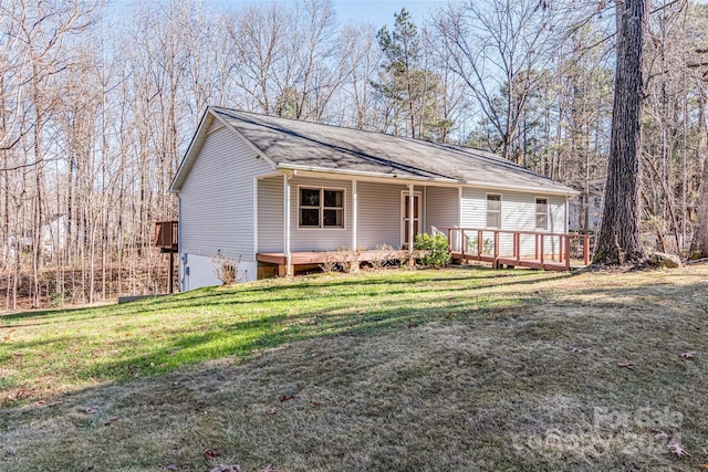 single story home featuring a deck and a front lawn