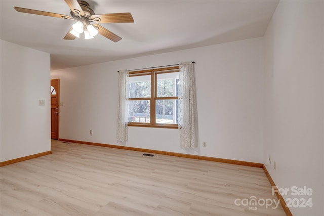 unfurnished room featuring ceiling fan and light wood-type flooring