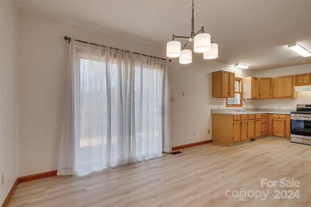 kitchen with decorative light fixtures, light hardwood / wood-style floors, stainless steel range, and a chandelier