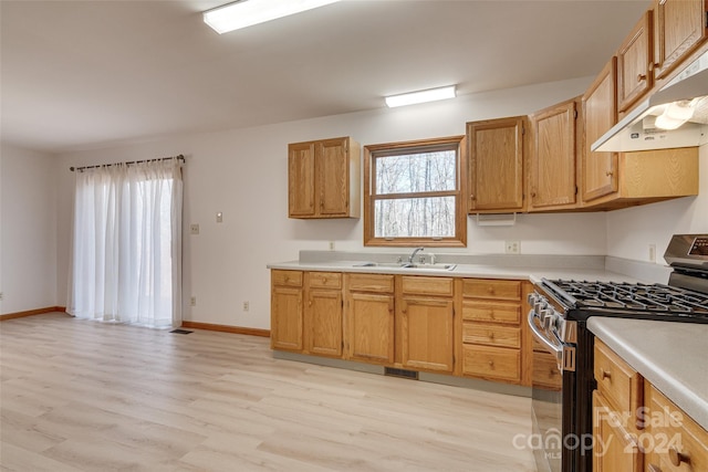 kitchen featuring sink, light hardwood / wood-style flooring, range hood, and gas range