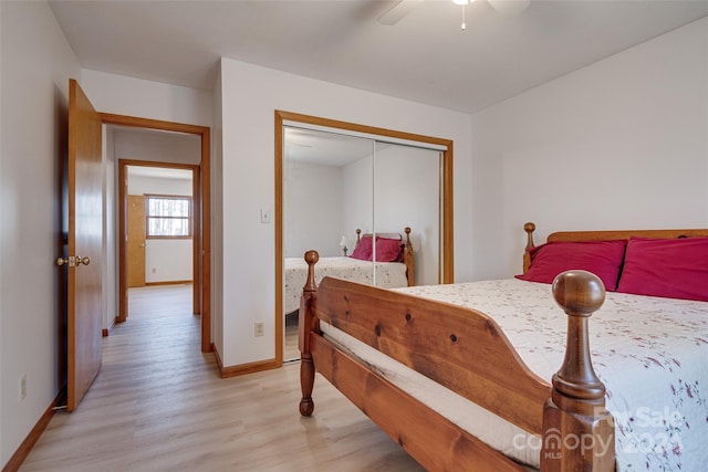 bedroom with a closet, light hardwood / wood-style floors, and ceiling fan