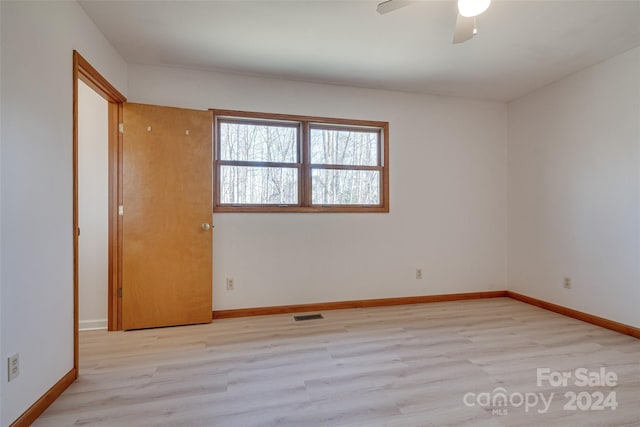 spare room featuring light wood-type flooring and ceiling fan