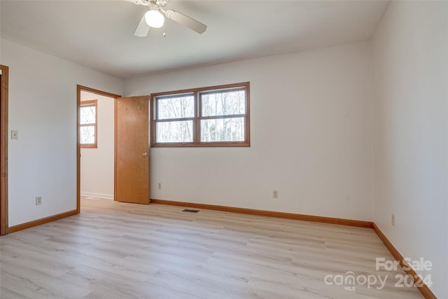 unfurnished room with ceiling fan and light hardwood / wood-style floors