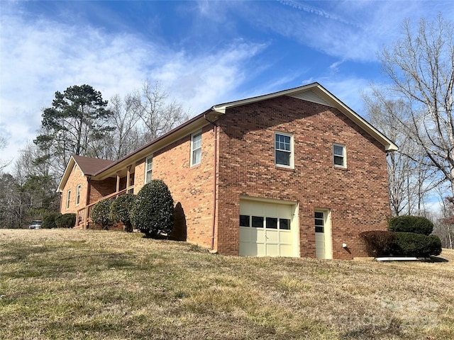 view of home's exterior with a garage and a yard