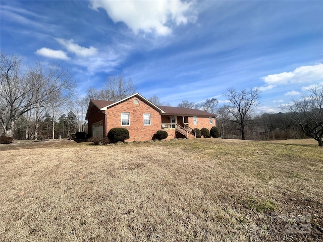 view of side of property featuring a garage and a lawn