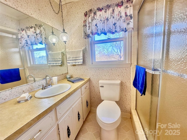 bathroom featuring a shower with door, vanity, tile patterned flooring, and toilet