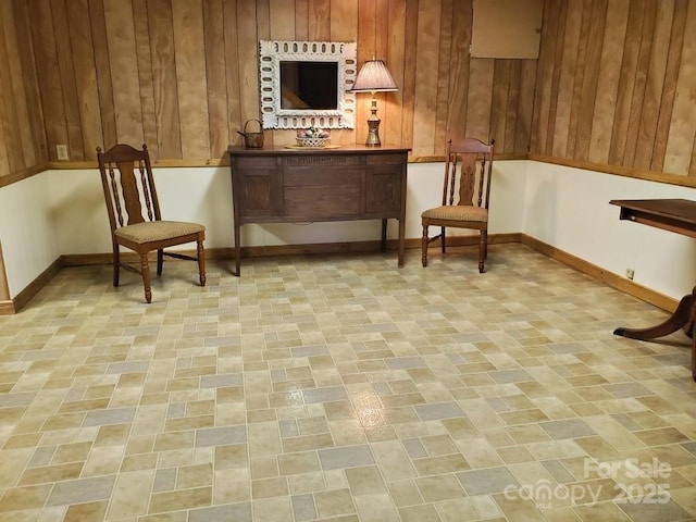 sitting room featuring wooden walls