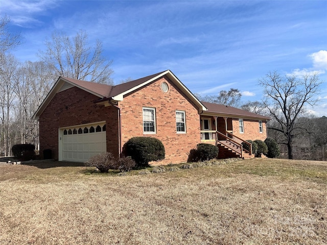 view of side of property featuring a garage and a lawn