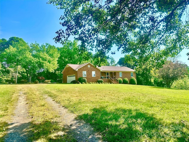 ranch-style home with a garage and a front lawn