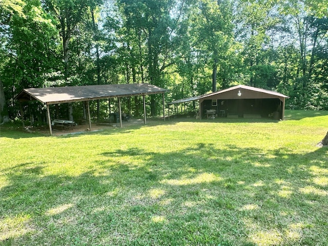 view of yard with a detached carport and a pole building