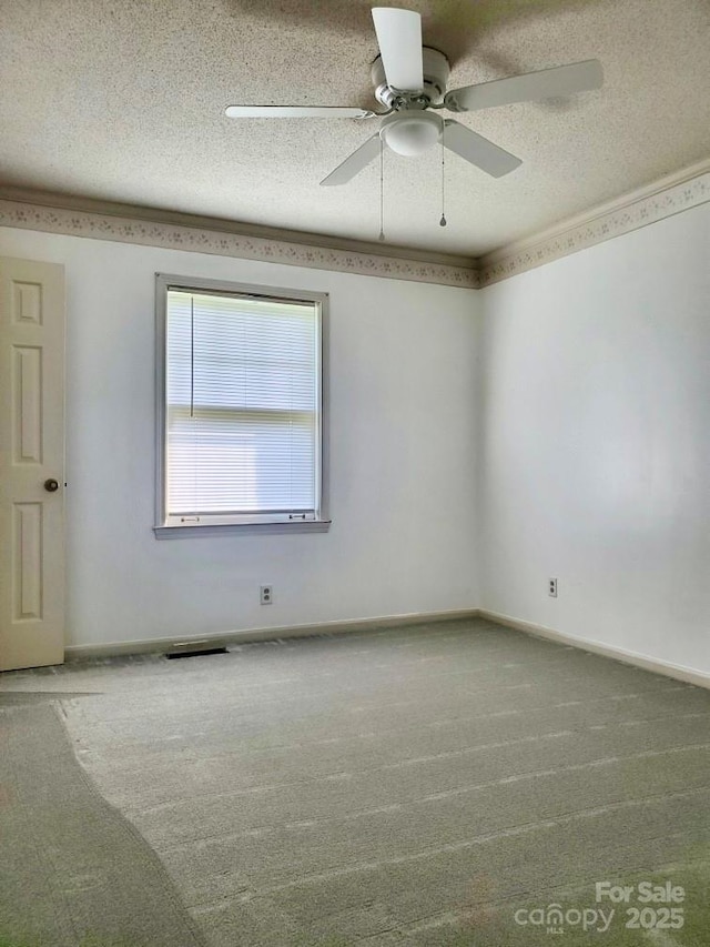 empty room featuring baseboards, a textured ceiling, ceiling fan, and carpet