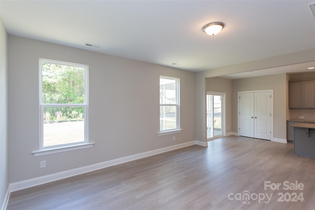 unfurnished living room with light hardwood / wood-style flooring