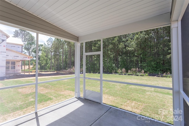 unfurnished sunroom with lofted ceiling