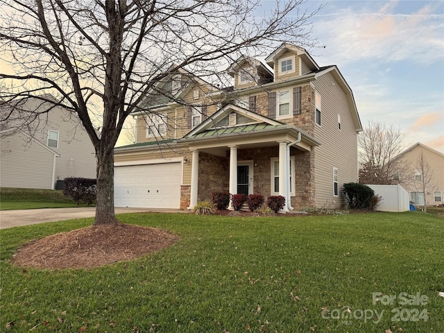 view of front facade with a garage and a front lawn